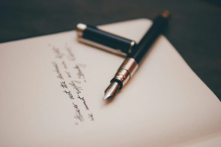 Open notebook and pen representing will planning