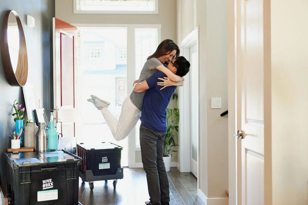 A couple embracing after moving into a home